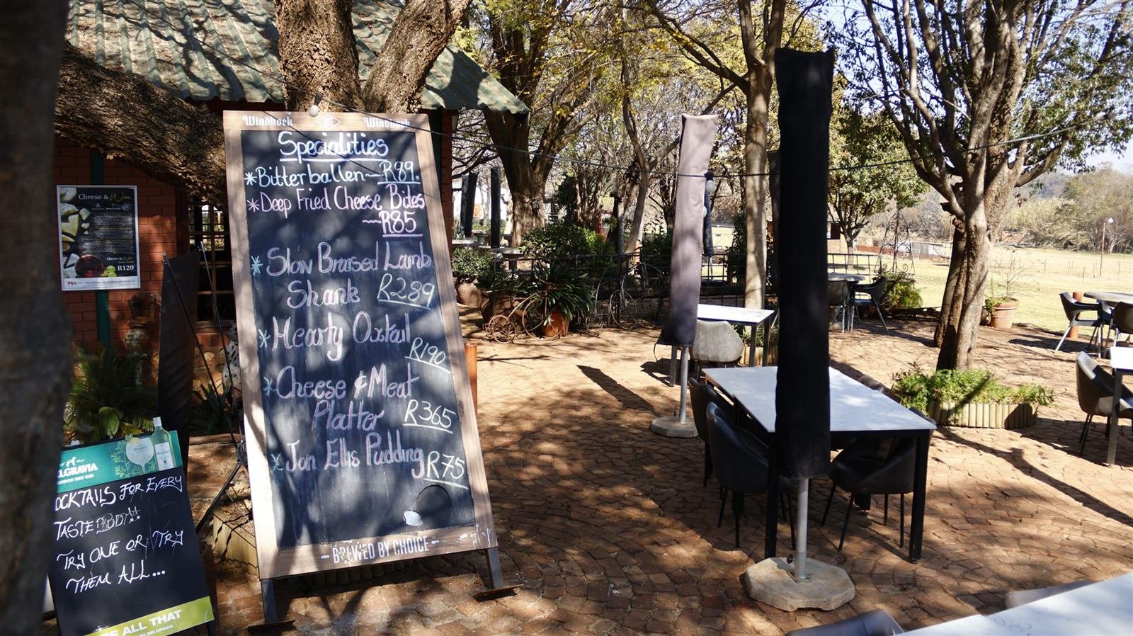 Terrace @ Van Gaalen patio at Van Gaalen, shaded tables under the trees